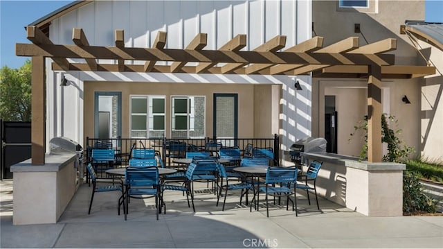 view of patio / terrace with area for grilling, grilling area, a pergola, and outdoor dining space