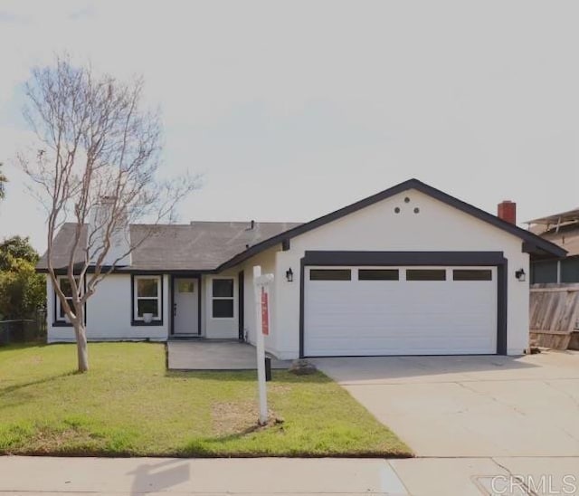 ranch-style house with a garage, concrete driveway, a front lawn, and stucco siding