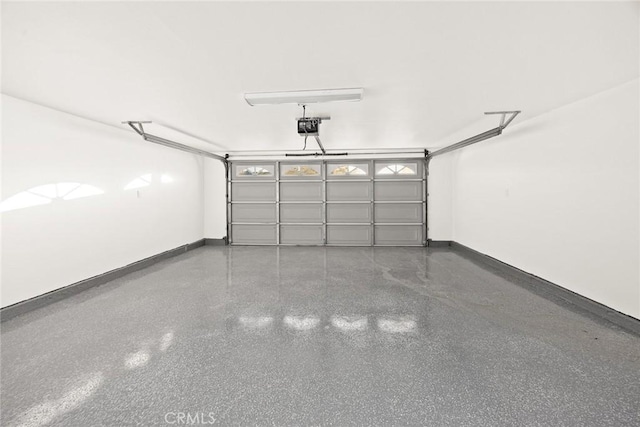 garage with a garage door opener and baseboards