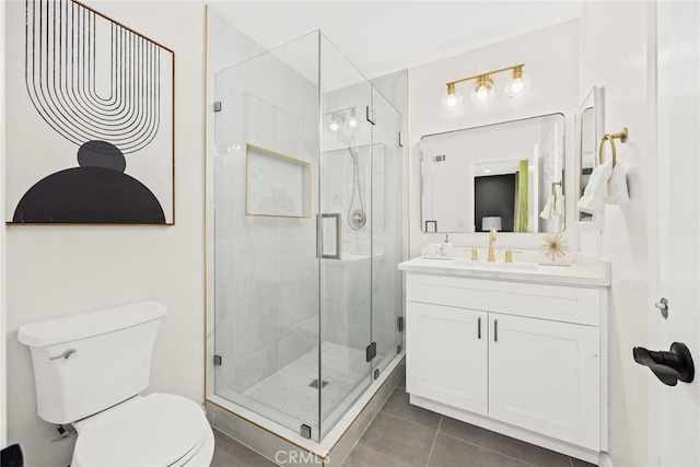 full bathroom featuring toilet, tile patterned floors, a shower stall, and vanity