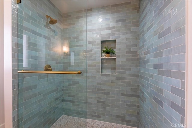 bathroom with a tile shower