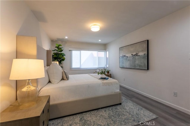 bedroom featuring baseboards and wood finished floors