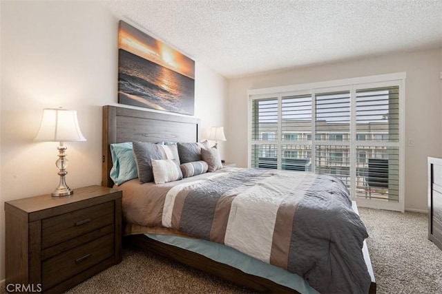 bedroom featuring carpet and a textured ceiling