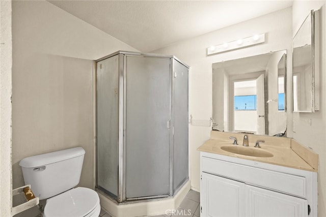 full bathroom with a stall shower, vanity, toilet, and tile patterned floors