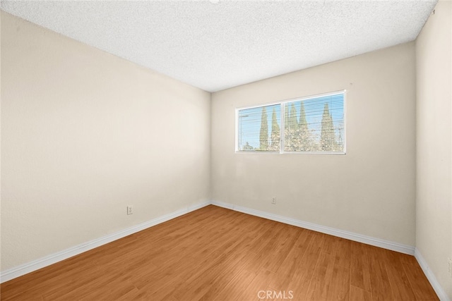 11331 Elliott Ave Unit 21, El Monte, CA 91732 - spare room featuring light wood-type flooring, baseboards, and a textured ceiling