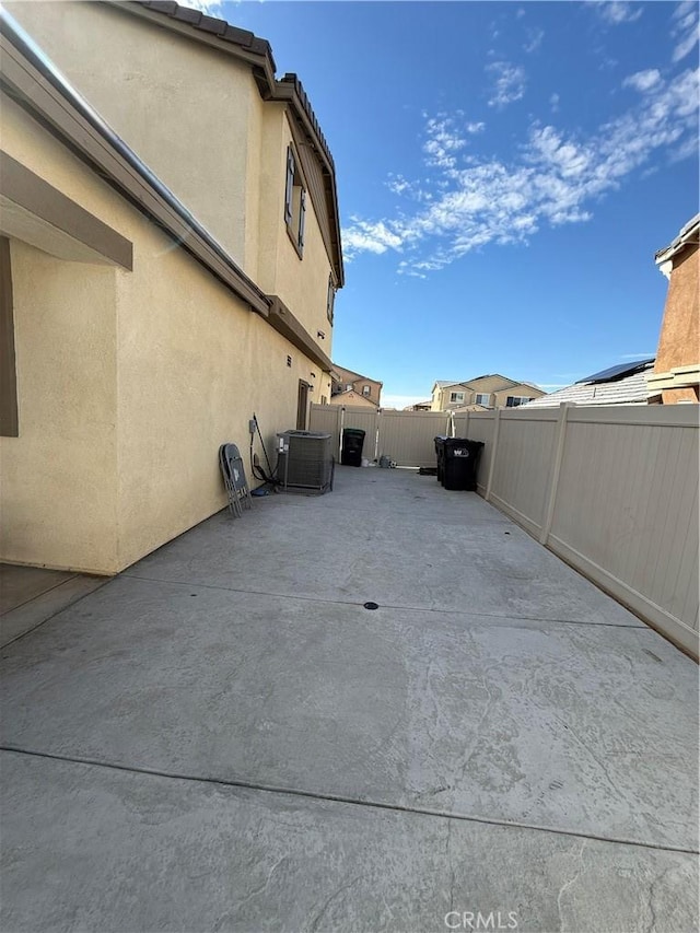 view of patio / terrace with a fenced backyard and central air condition unit