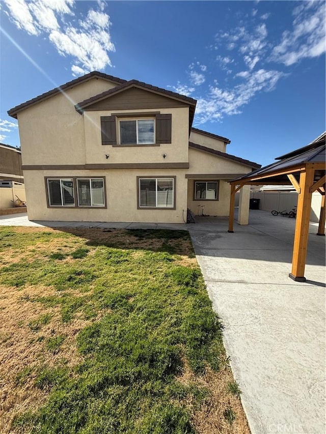 traditional-style house with a front yard and stucco siding