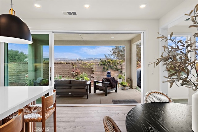 doorway to outside featuring recessed lighting, visible vents, and wood finished floors