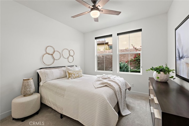 bedroom featuring carpet floors, baseboards, and a ceiling fan