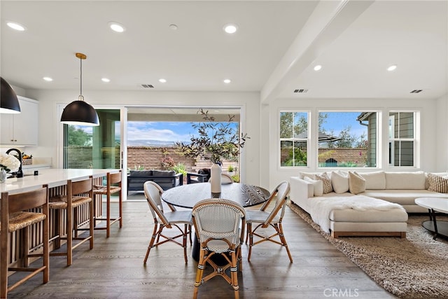 dining area featuring wood finished floors, visible vents, and recessed lighting