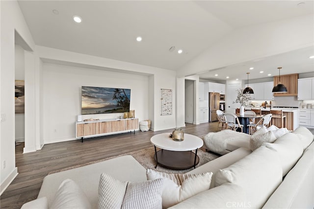 living area with recessed lighting, dark wood-style flooring, vaulted ceiling, and baseboards