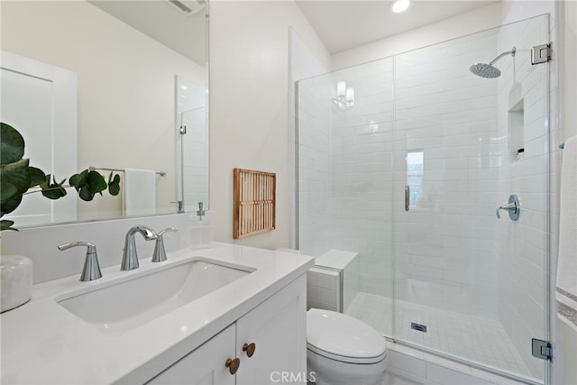 full bath featuring a stall shower, vanity, and toilet