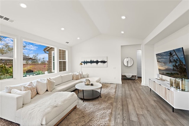 living area with lofted ceiling, recessed lighting, wood finished floors, visible vents, and baseboards