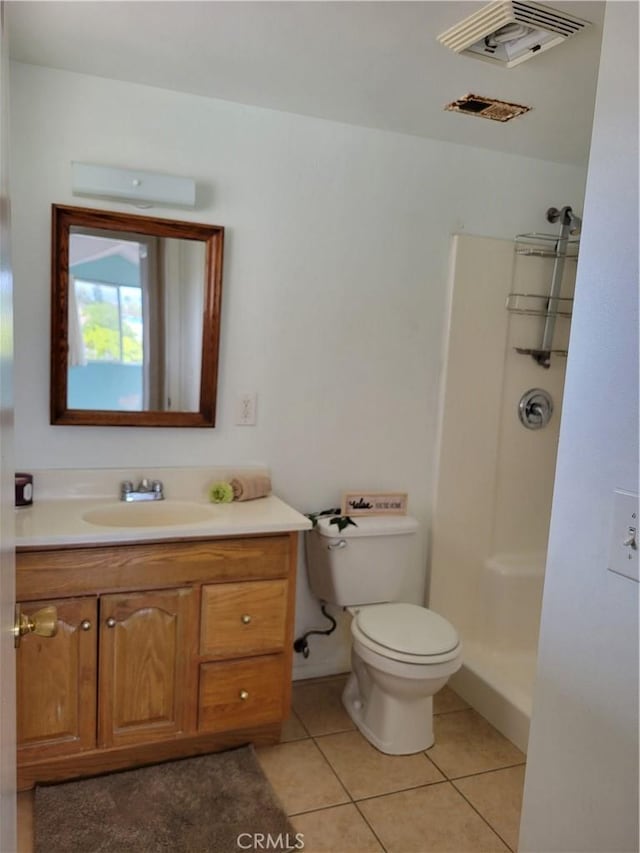 full bathroom featuring vanity, visible vents, tile patterned flooring, a walk in shower, and toilet