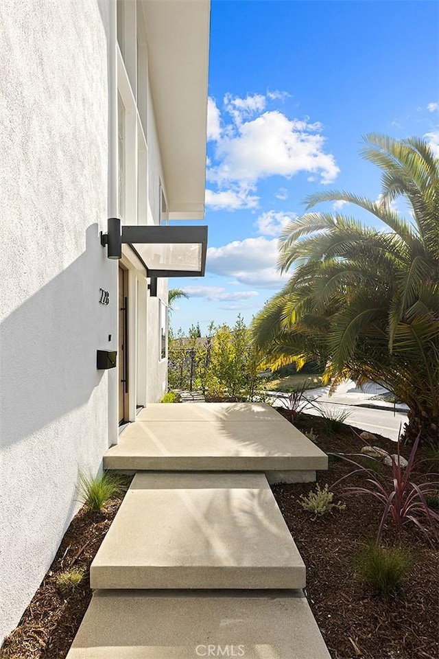 view of exterior entry featuring stucco siding