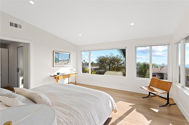 bedroom with lofted ceiling, light wood-style flooring, recessed lighting, visible vents, and baseboards