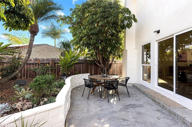 view of patio featuring outdoor dining space and a fenced backyard