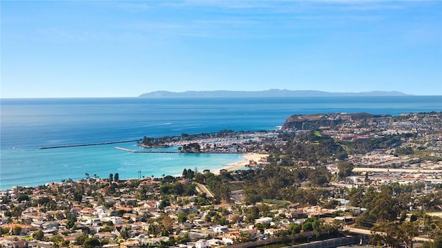 birds eye view of property with a water and mountain view