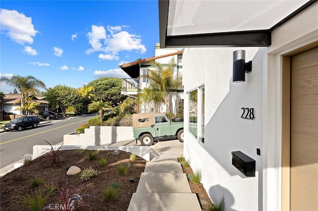 view of property exterior with a residential view and stucco siding