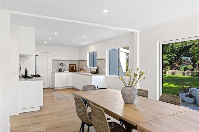 dining room featuring light wood-style flooring and recessed lighting