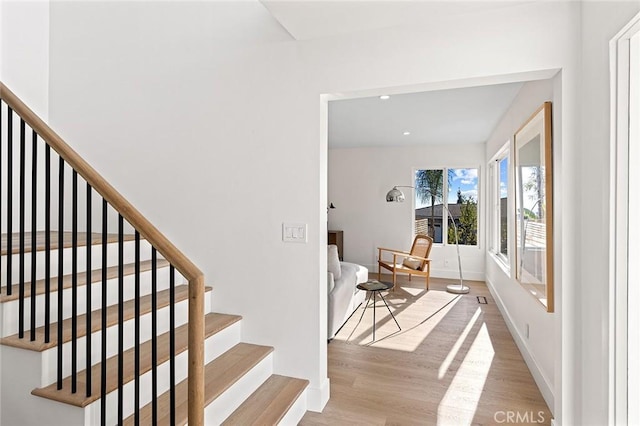 stairs featuring recessed lighting, baseboards, and wood finished floors