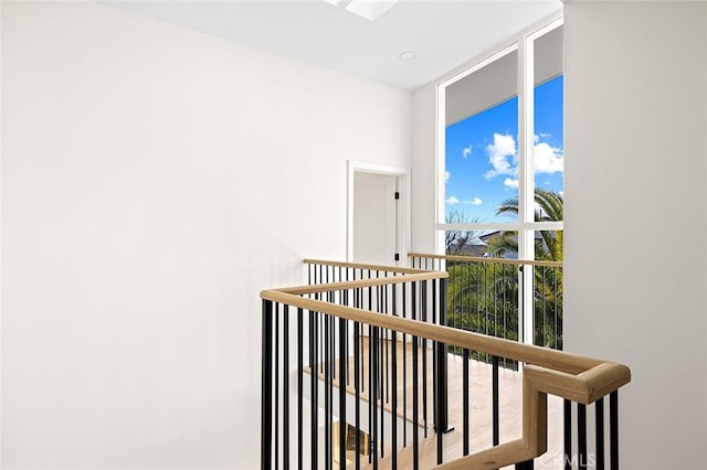 corridor featuring expansive windows and a skylight