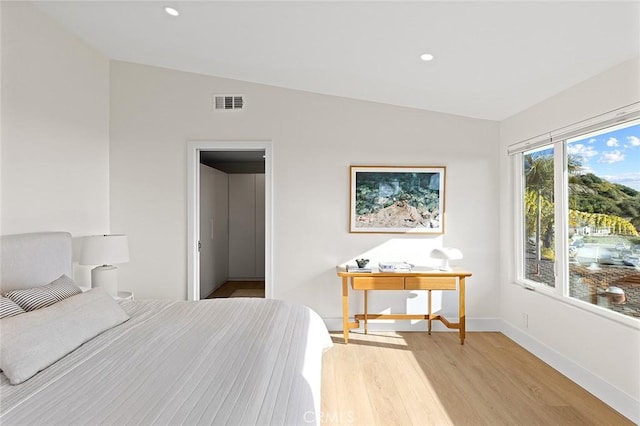 bedroom with light wood-style floors, recessed lighting, visible vents, and baseboards