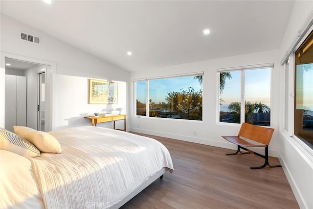 bedroom with baseboards, visible vents, lofted ceiling, wood finished floors, and recessed lighting