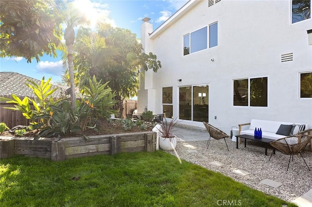 back of house with fence, a lawn, a patio, and stucco siding