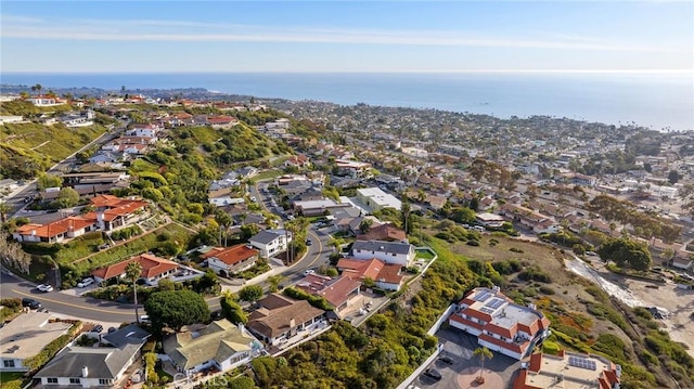 drone / aerial view featuring a water view and a residential view