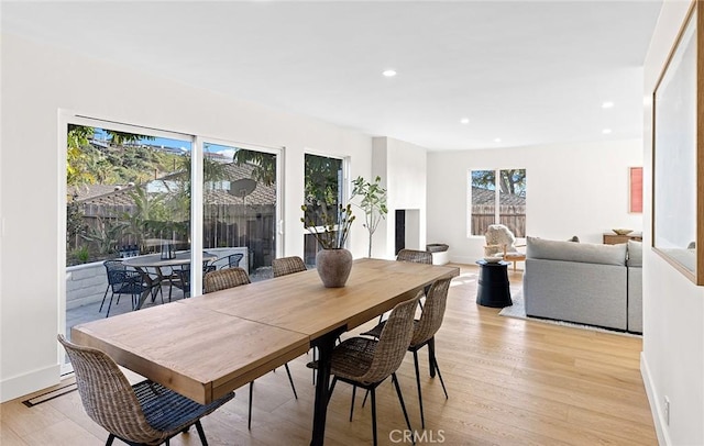 dining space featuring light wood-style floors, recessed lighting, and baseboards