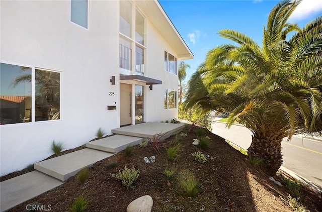 property entrance featuring stucco siding