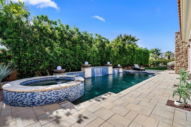 view of swimming pool with a patio area and a pool with connected hot tub