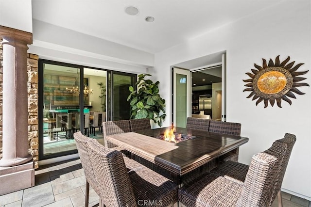 dining area featuring decorative columns