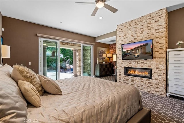 bedroom with access to outside, a fireplace, a ceiling fan, and carpet flooring