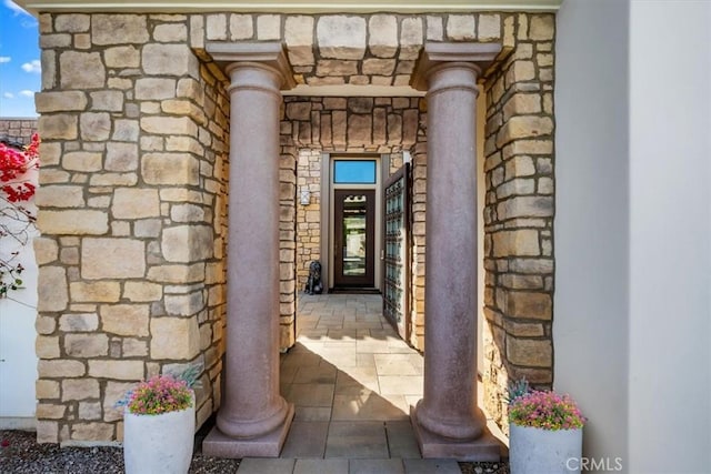 property entrance with stone siding