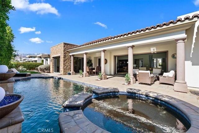 view of pool with a pool with connected hot tub, a patio area, and an outdoor living space