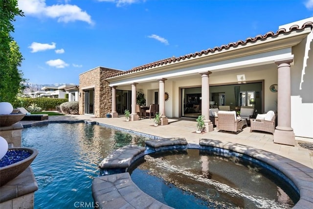 back of property with an outdoor hangout area, a tile roof, a patio area, stucco siding, and a pool with connected hot tub