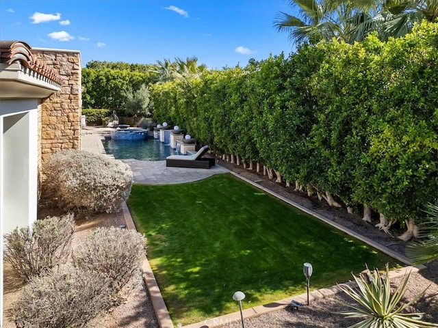 view of yard featuring an outdoor pool, an in ground hot tub, and a patio area