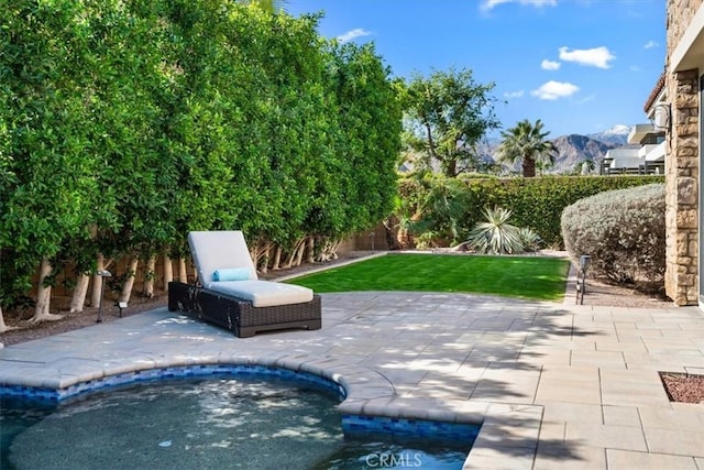 view of patio / terrace featuring a fenced backyard and a mountain view