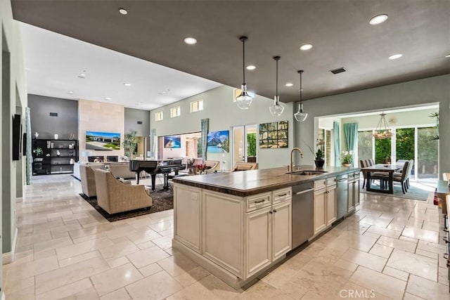 kitchen featuring a center island with sink, dark countertops, recessed lighting, a sink, and dishwasher