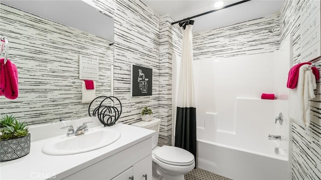 bathroom with vanity, shower / bathtub combination with curtain, toilet, and wallpapered walls