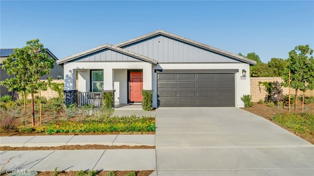 modern inspired farmhouse featuring an attached garage and concrete driveway