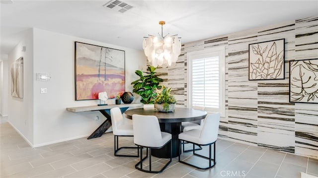 dining room featuring a chandelier, visible vents, and baseboards