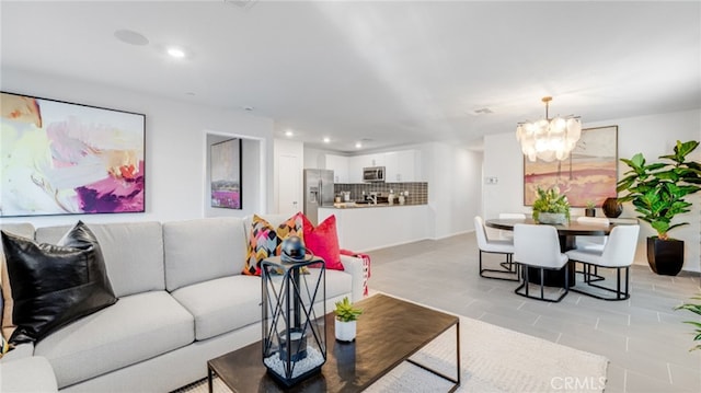 living room with recessed lighting, light tile patterned flooring, and a notable chandelier