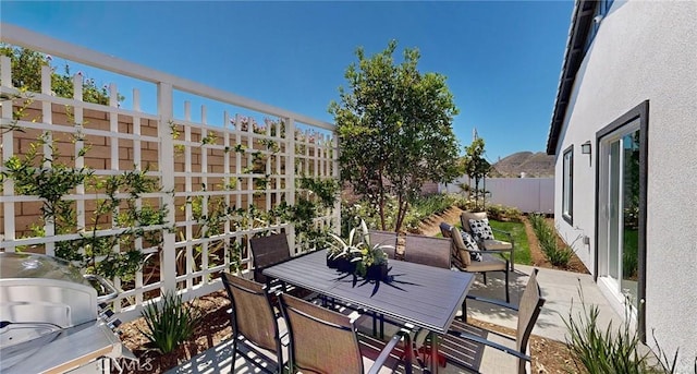 view of patio featuring a fenced backyard, grilling area, and outdoor dining space