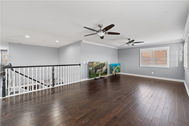 unfurnished room featuring crown molding, baseboards, and dark wood-style flooring