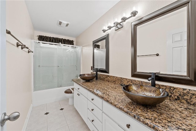 bathroom featuring toilet, visible vents, a sink, and tile patterned floors