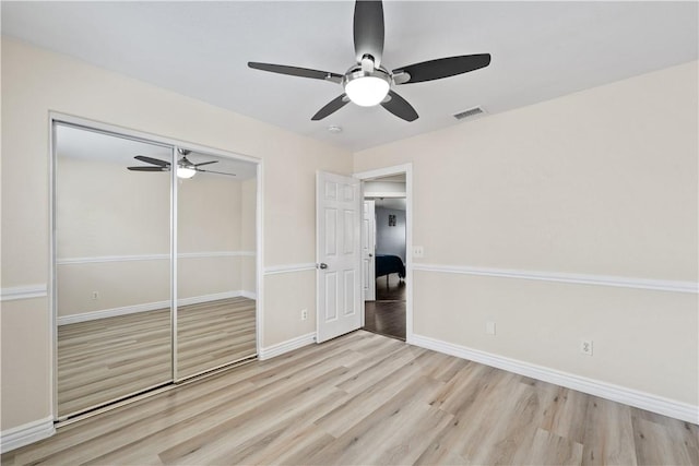 unfurnished bedroom with a ceiling fan, baseboards, visible vents, and light wood finished floors