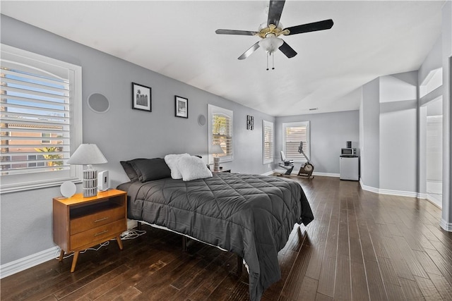 bedroom with dark wood-style floors, ceiling fan, and baseboards